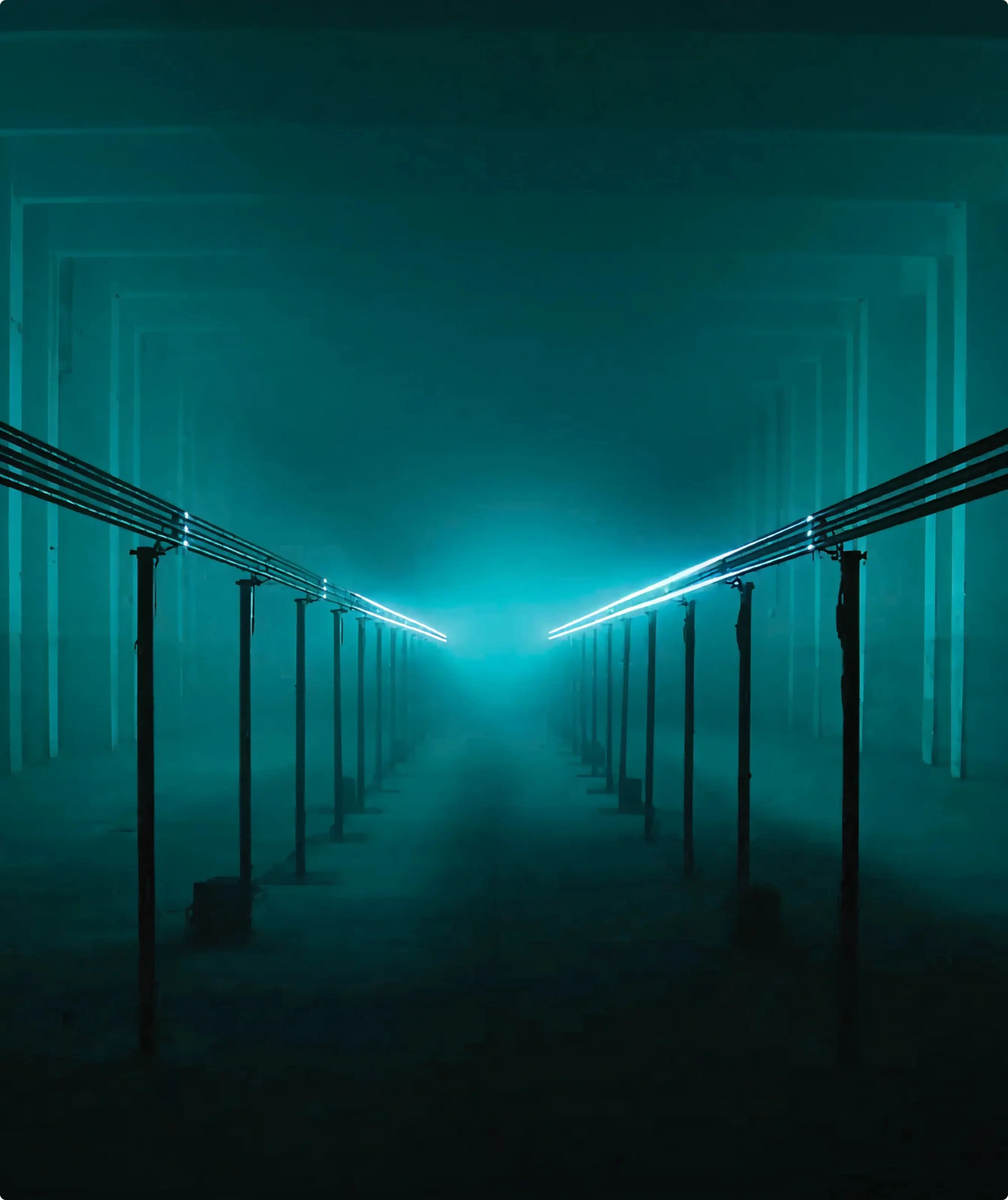 Moody industrial corridor transformed with blue neon lighting for an immersive art installation.