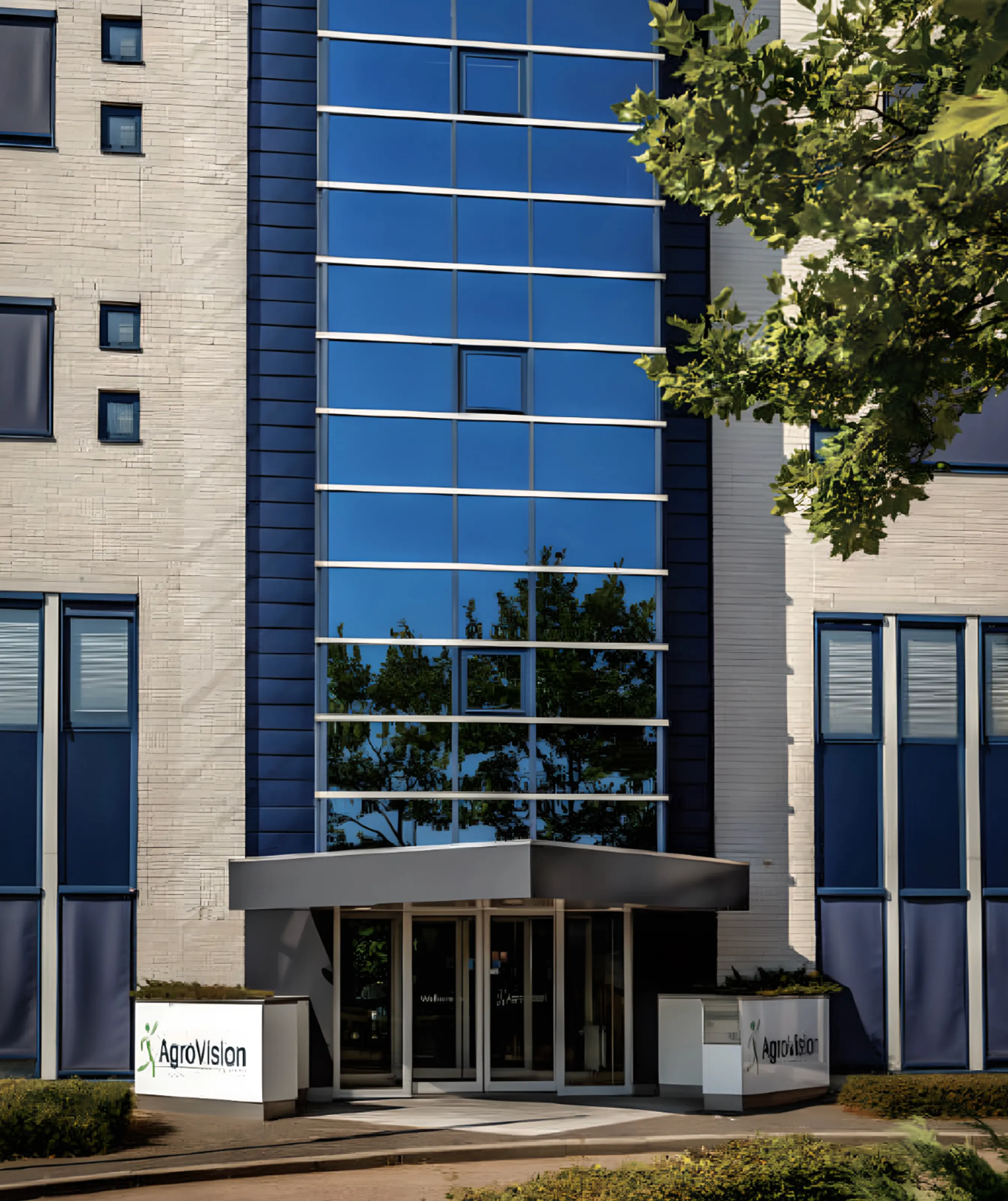 A modern office entrance with large blue-tinted glass windows and AgroVision signage outside the building.